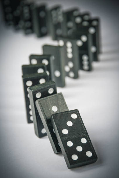 istock Black dominoes chain on table background 1406148758