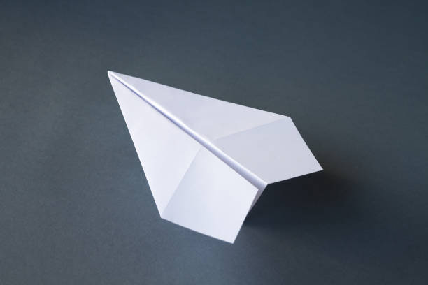istock White paper plane origami isolated on a grey background 1406149609