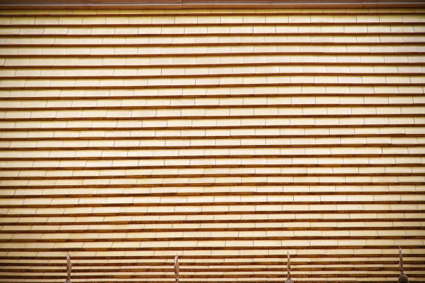 Close-up view of a traditional japanese reed screen, showcasing its intricate texture and craftsmanship