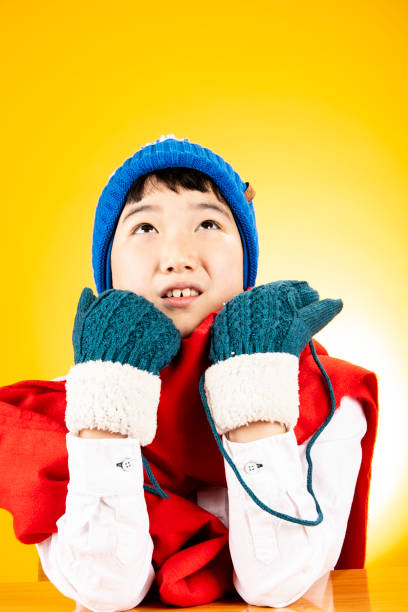The boy is happy in a fur hat and scarf