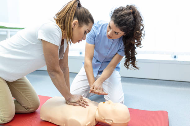 istock CPR class with instructors talking and demonstrating firt aid, compressions ans reanimation procedure. Cpr dummy 1406151300