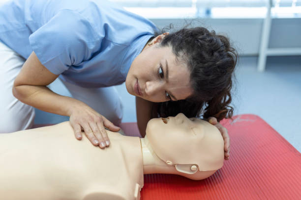 istock CPR class with instructors talking and demonstrating firt aid, compressions ans reanimation procedure. Cpr dummy 1406151349