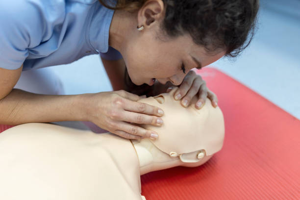 istock CPR class with instructors talking and demonstrating firt aid, compressions ans reanimation procedure. Cpr dummy 1406151369