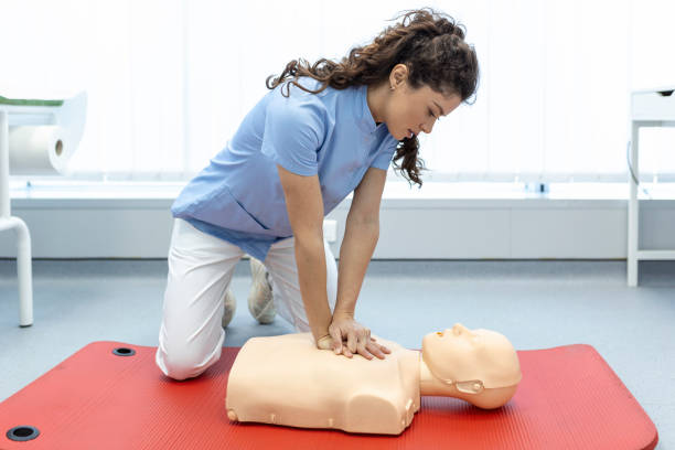 istock CPR class with instructors talking and demonstrating firt aid, compressions ans reanimation procedure. Cpr dummy 1406152088