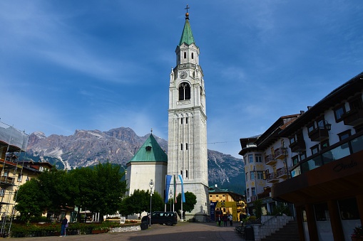 Cortina d ampezzo, Italy - June 21 2022: View of Basilica of Saints Philip and James in Cortina d ampezzo in Veneto region and Belluno province in Italy with Dolomite Mountains behind