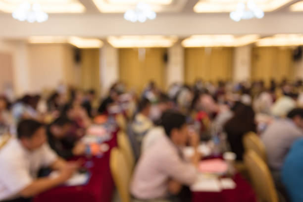 istock Education concept, Abstract blurred background image of students and business people studying and discuss in large hall profession seminar with screen 1406152848
