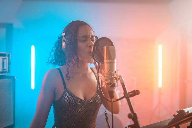 istock Charming Hispanic Young Woman Singing in Recording Studio 1406155679