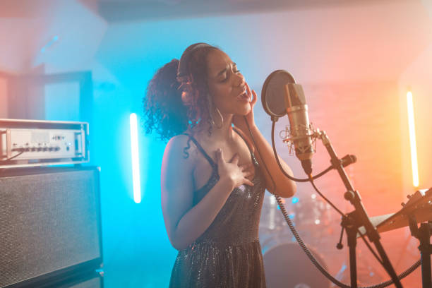 istock Engaged Hispanic Young Singer in Recording Studio 1406155692
