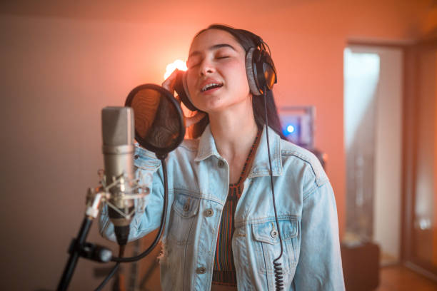 istock Young Asian Lovely Woman Singing in Recording Studio 1406155694