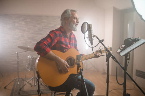 istock Senior Caucasian Guitarist Playing Classical Guitar in Recording Studio 1406155720