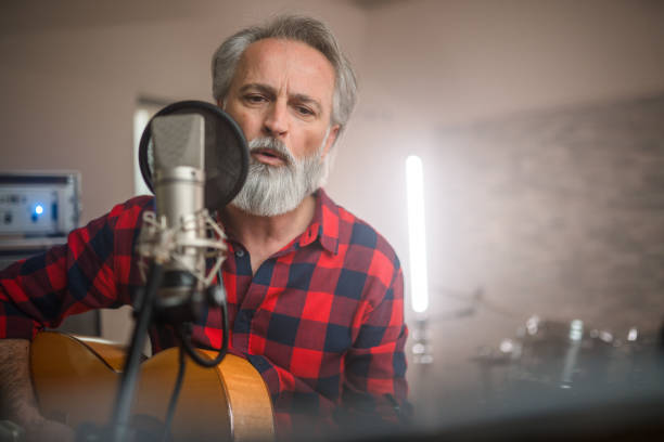 istock Senior Caucasian Guitarist Playing Classical Guitar in Recording Studio 1406155726