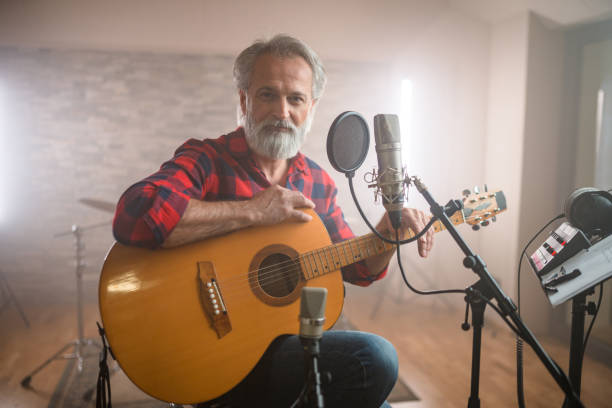 istock Senior Caucasian Guitarist Playing Classical Guitar in Recording Studio 1406155753