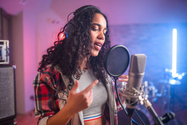 istock Young Hispanic Beautiful Woman With Eyes Closed Singing in Recording Studio 1406156404