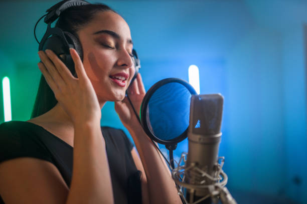 istock Young Asian Beautiful Woman Singing in Recording Studio 1406156405