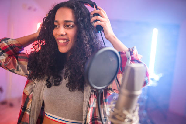 istock Young Hispanic Beautiful Woman Singing in Recording Studio 1406156420