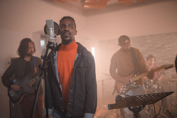 istock Multi-Ethnic Music Group Recording Songs In Music Recording Studio 1406156441