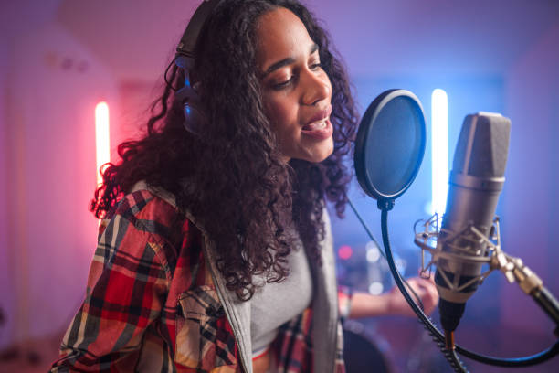istock Young Hispanic Beautiful Woman With Eyes Closed Singing in Recording Studio 1406156445