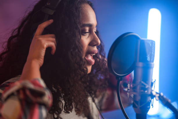 istock Young Hispanic Beautiful Woman Singing in Recording Studio 1406156453