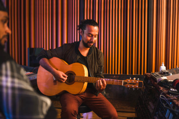 istock Two Male Musicians Composing Music in Recording Studio Mixer 1406156729