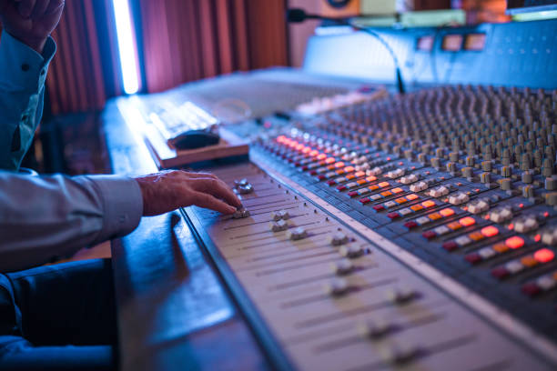 istock Senior Male Composer Composing Songs During the Night in Recording Studio 1406156805
