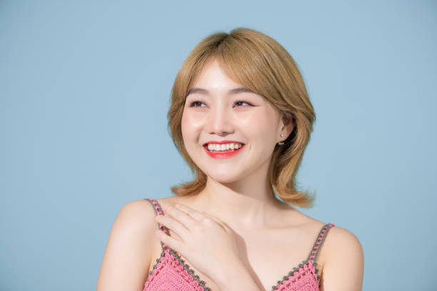 istock young pretty asian woman cute face expression posing on pastel blue background isolated, emotional, funny 1406156851