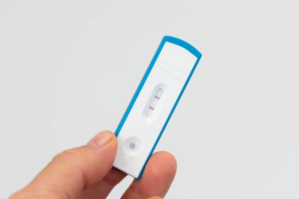 istock Hand holding a positive COVID RAT test 1406157932