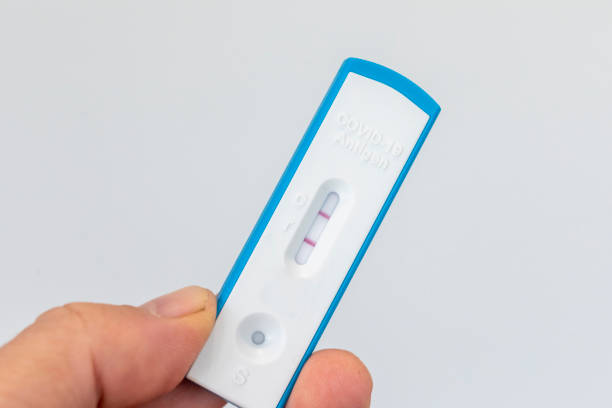 istock Hand holding a positive COVID RAT test 1406157941