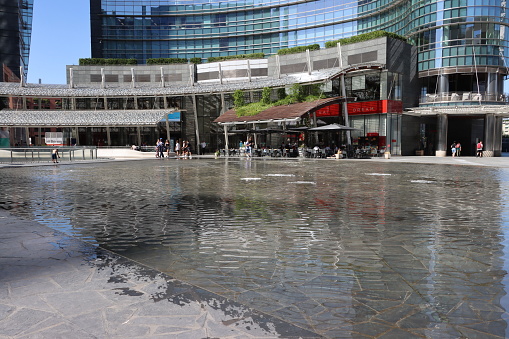 Piazza Gae Aulenti - Milan - Italy - June 30, 2022. The use of water is limited in Milan decorative fountains to fight drought.