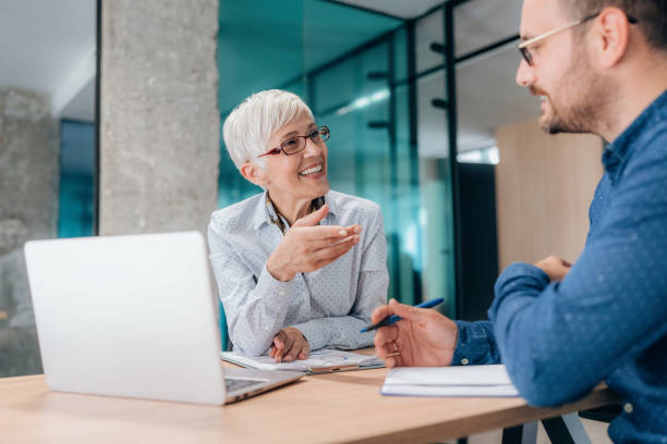 istock Two business people working together in office 1406160403