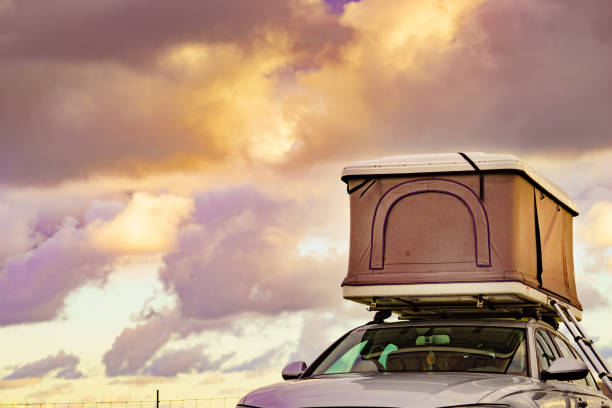Car with roof top tent against sky. Holidays and traveling.