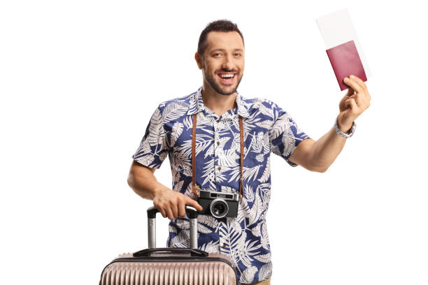 istock Happy young man with a suitcase showing a passport and smiling 1406161408