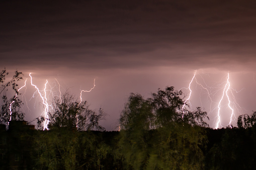 Night shot of stunning lightning strikes over non-urban landscape