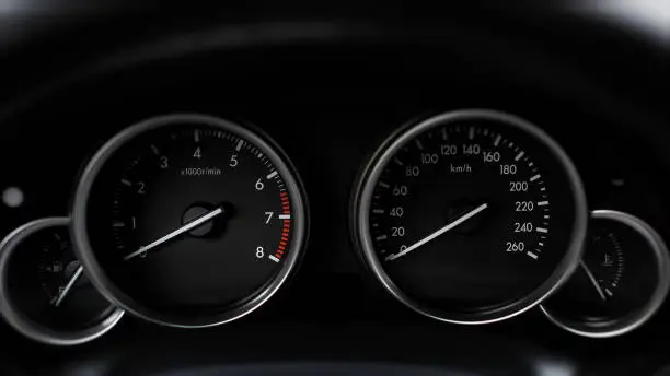 Photo of Modern car dashboard with RPM and Miles Per Hour Speedometer Close Up.