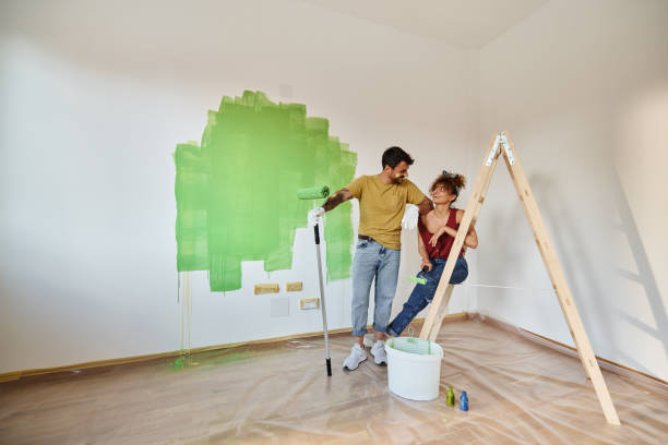 istock Happy couple talking while painting their new apartment. 1406164453