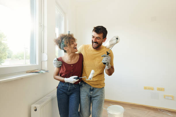 istock Cheerful couple having fun during home renovation process. 1406165712