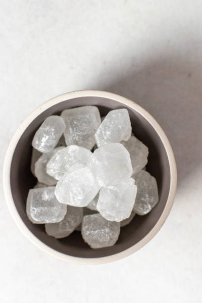 Bowl of refined sugar crystals stock photo
