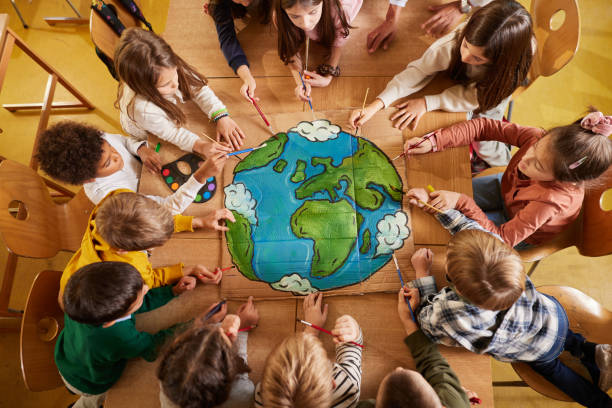 Above view of students drawing a planet on art class at elementary school.