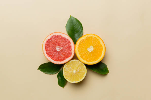 Fruit background. Colorful fresh fruits on colored table. Orange, lemon, grapefruit Space for text healthy concept. Flat lay, top view, copy space