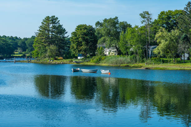 istock Three boats on a lake in New England 1406168415