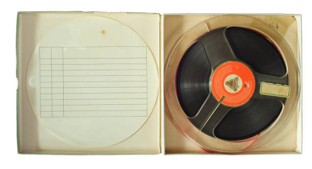 Vintage magnetic audio reel in cardboard box and blank paper inlay, free copy space Vintage magnetic audio reel in cardboard box and blank paper inlay, free copy space reel to reel tape stock pictures, royalty-free photos & images