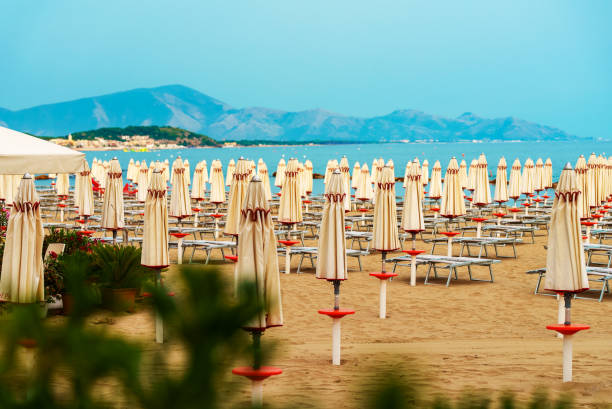 istock Sun loungers and umbrellas on the private beach. 1406171027
