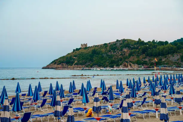 Photo of Sun loungers and umbrellas on the beach in Scauri, Italy.