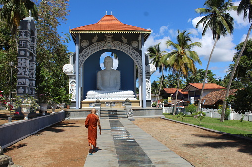 Godauda, Sri Lanka – April 26, 2022: A monk walks around Sri Sumanarama Viharaya Temple, a Buddhist complex in Godauda.