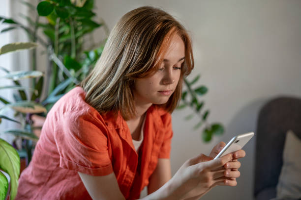 istock YYoung female using smartphone at home checking email, writing message in social network, searching information. 1406172278