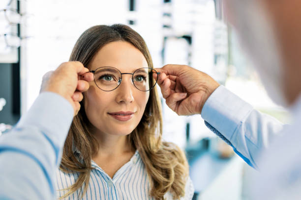 istock Customer in optic store trying on eyewear 1406172834