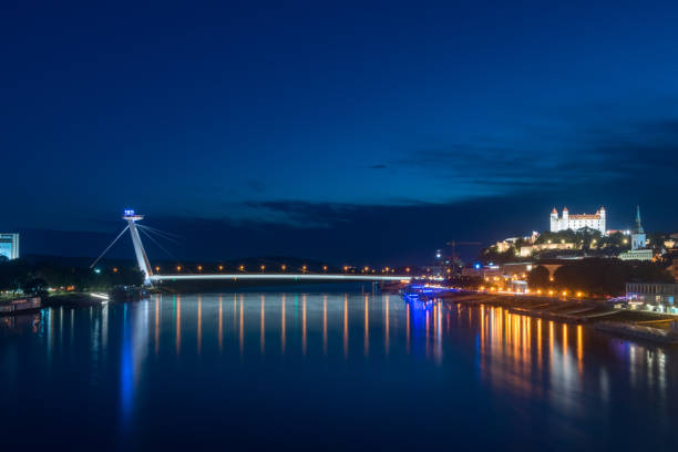 Bratislava, Slovakia - May 31, 2022: Night view on Danube river, National Uprising bridge and Bratislava castle.