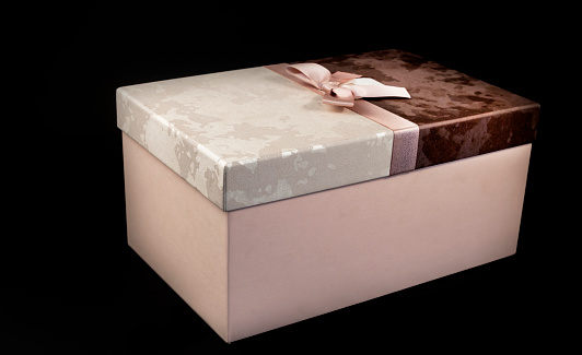 Black friday gift box with pink bow on black background. Copy space. Horizontal, banner, postcard.