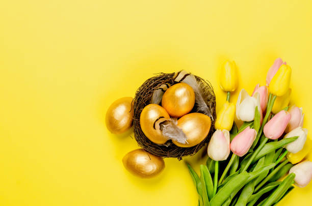 istock Easter gold decorative eggs in the nest on yellow 1406175920