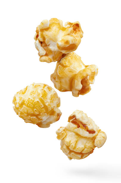 Flying delicious caramel popcorn on white