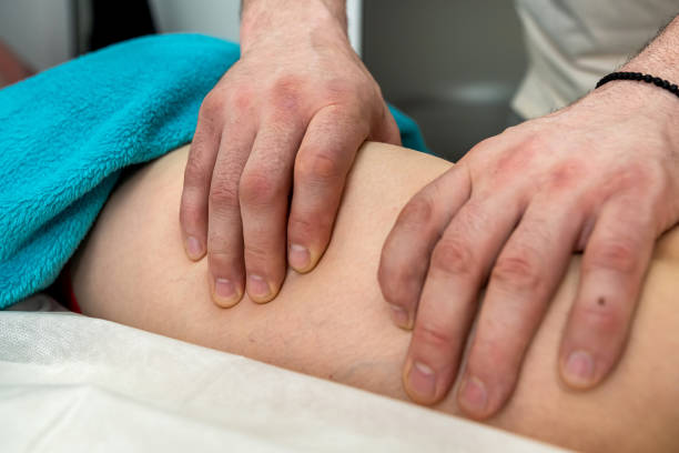 istock therapist doing female client massaging  legs in spa salon 1406177065